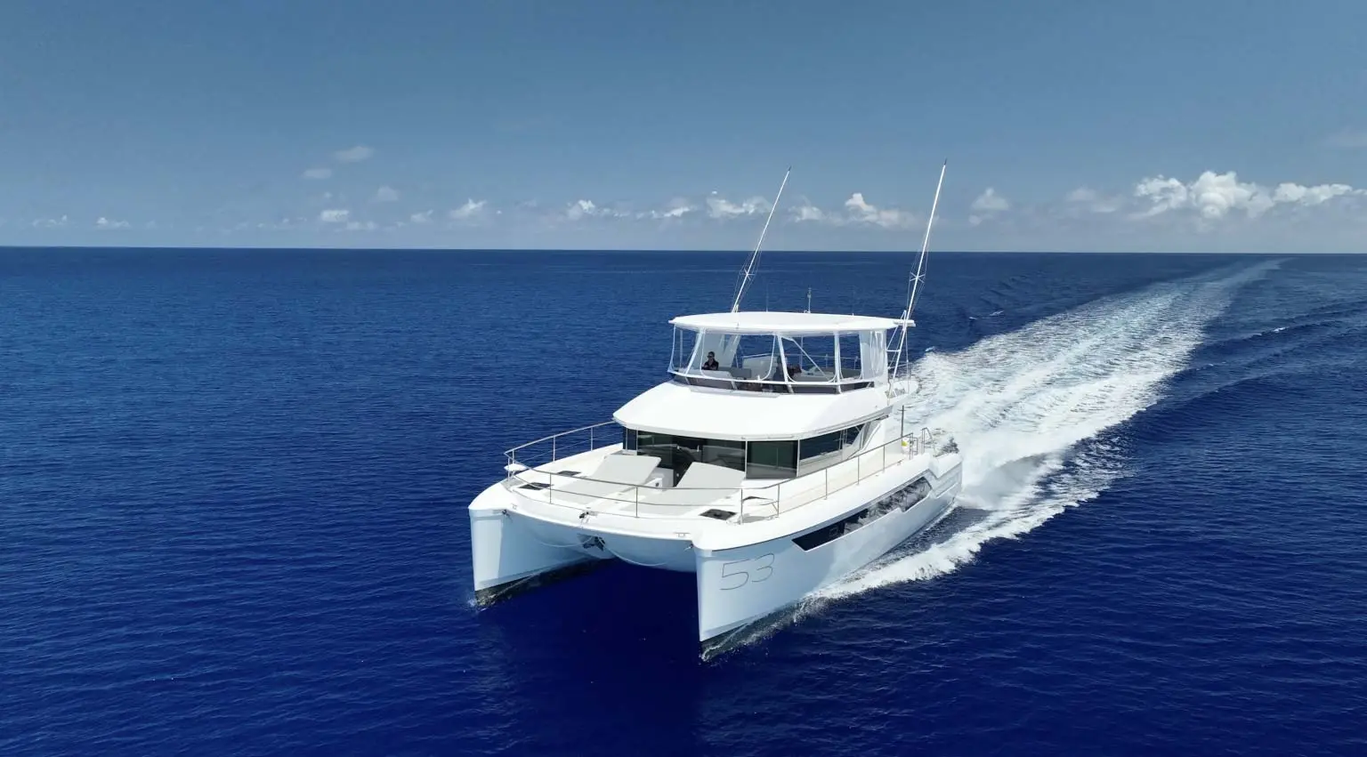 Blue Moon, a 53-foot Leopard power catamaran, cruising over deep blue water