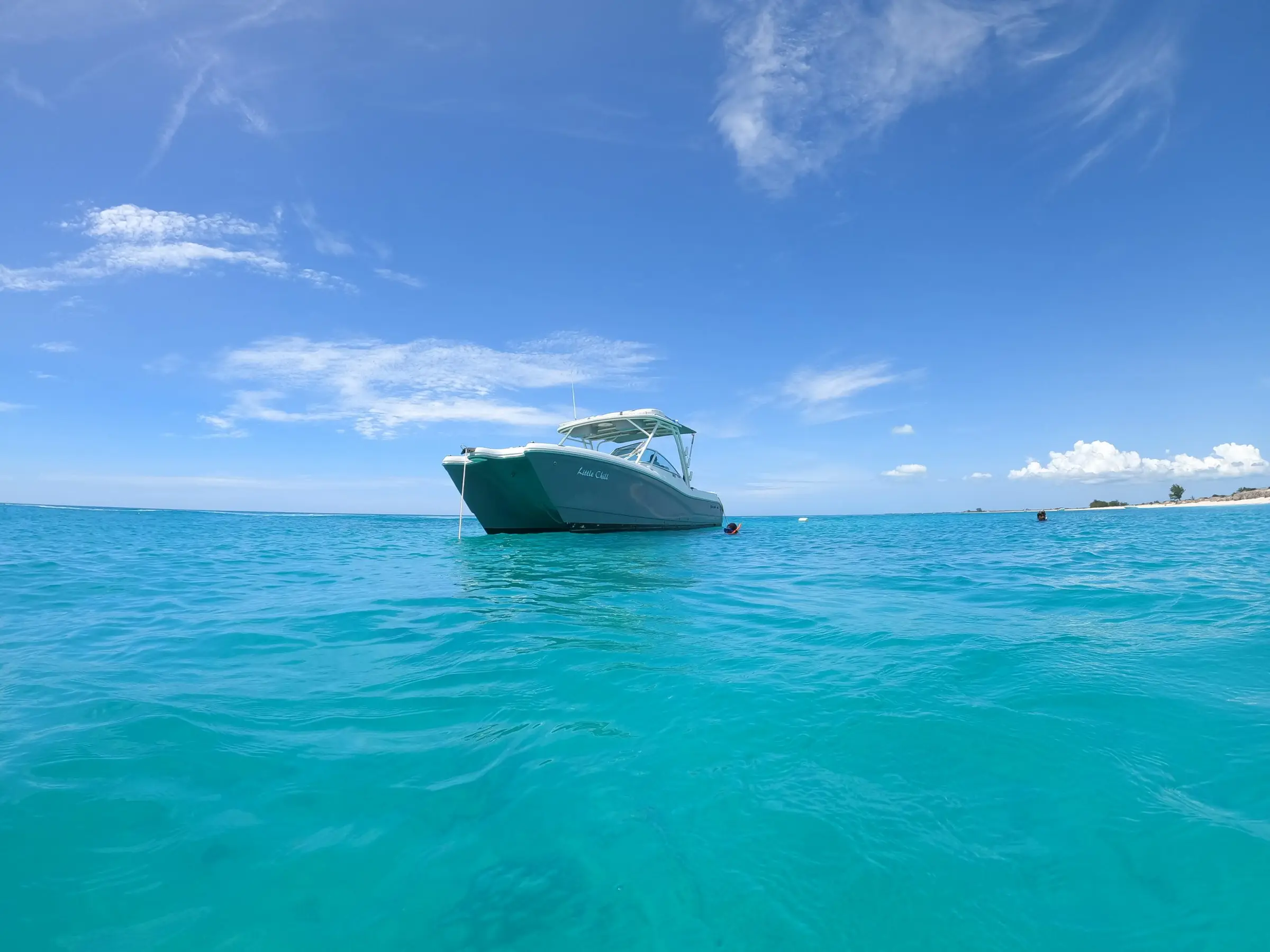 Little Chill, a 30-foot power catamaran, anchored off a quiet beach